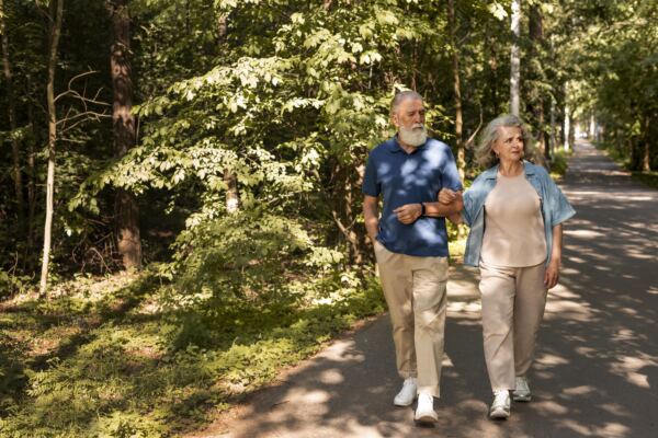 full shot senior couple walking together - Booking-Senior.com