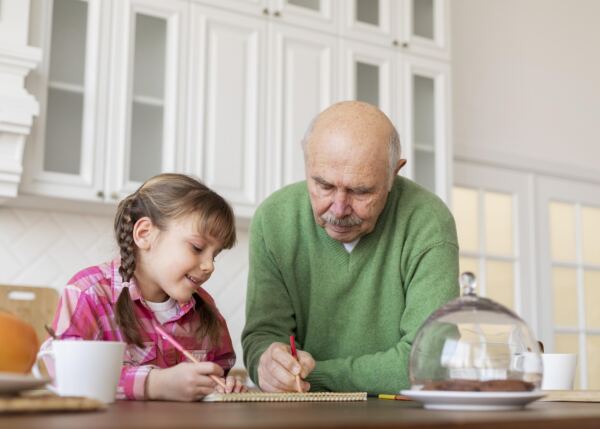 medium shot grandpa girl drawing - Booking-Senior.com